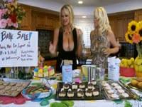 An innocent bake sale turns raunchy when two milfs fuck with a strap on and then share a lucky dudes cock after they are done