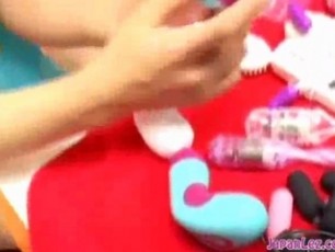 2 Asian Girls Stimulating Nipples And Pussies With Various Toys On The Carpet In The Room